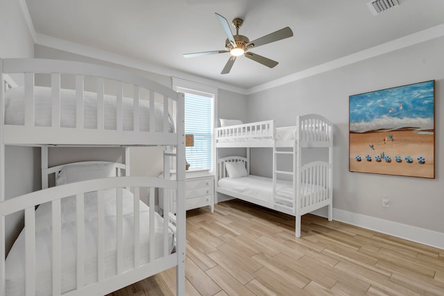 bedroom featuring ceiling fan, ornamental molding, and light hardwood / wood-style floors