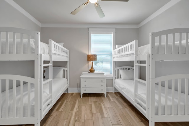 bedroom with crown molding, light hardwood / wood-style floors, and ceiling fan