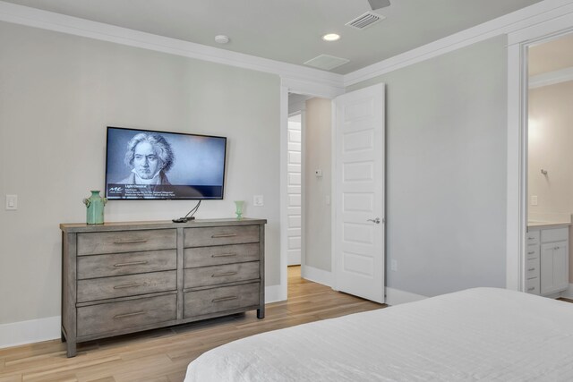 bedroom with ensuite bath, light hardwood / wood-style floors, and crown molding