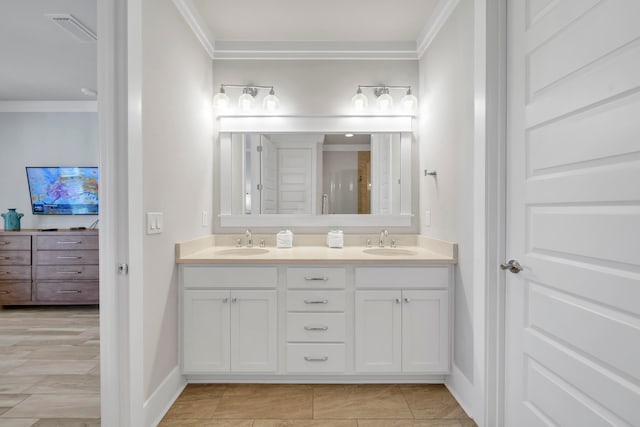 bathroom with ornamental molding and vanity