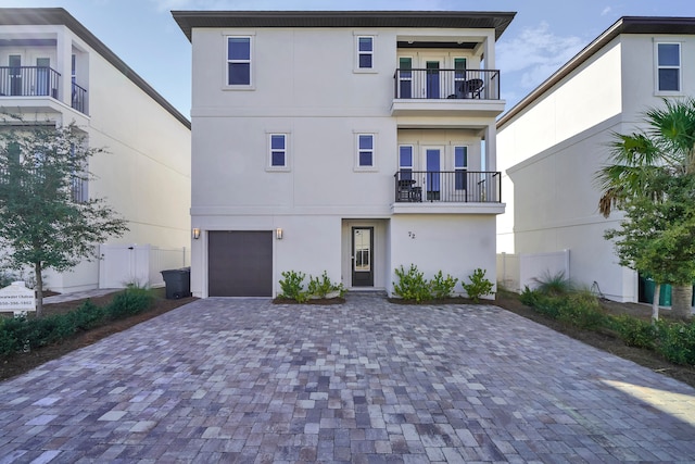 view of front of house featuring a balcony and a garage