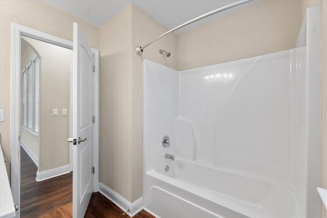 bathroom with tub / shower combination and hardwood / wood-style floors