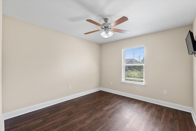 spare room featuring ceiling fan and dark wood-type flooring