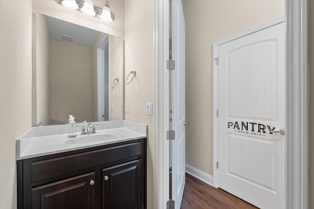 bathroom featuring hardwood / wood-style floors and vanity