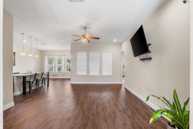 living room featuring dark hardwood / wood-style flooring and ceiling fan