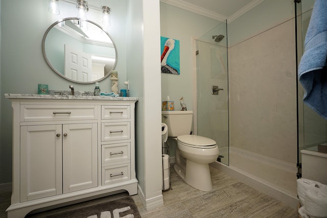 bathroom featuring walk in shower, crown molding, vanity, and toilet