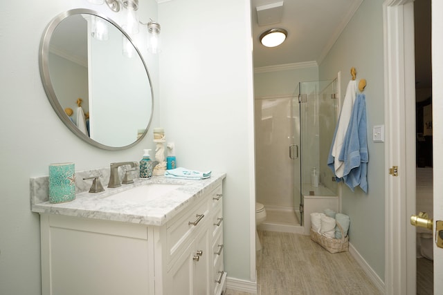 bathroom featuring vanity, walk in shower, hardwood / wood-style floors, ornamental molding, and toilet