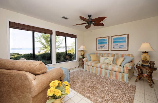 living room featuring light tile patterned flooring and ceiling fan