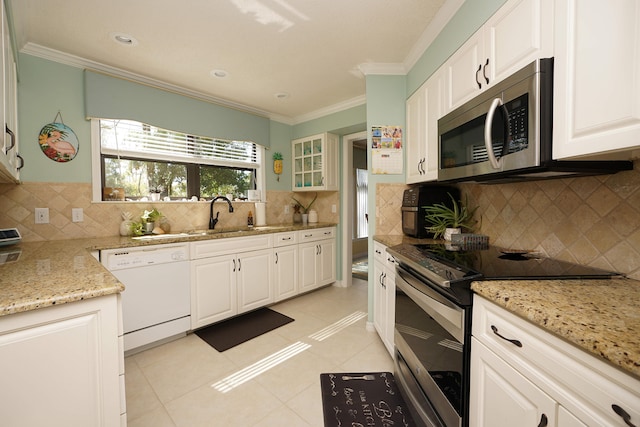 kitchen featuring appliances with stainless steel finishes, white cabinetry, sink, and light tile patterned floors