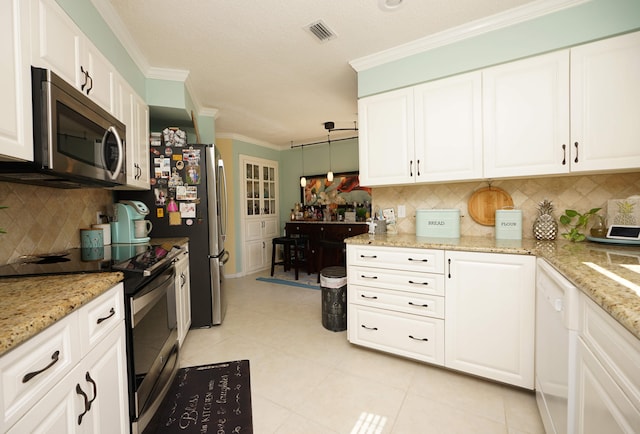 kitchen with appliances with stainless steel finishes, crown molding, pendant lighting, and white cabinets