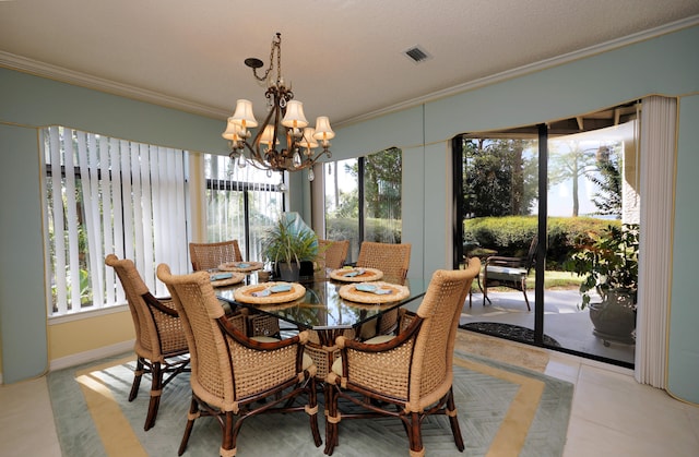 tiled dining room featuring a textured ceiling, ornamental molding, and a notable chandelier