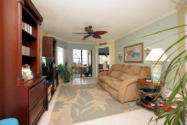 living room with a textured ceiling, light tile patterned floors, ornamental molding, and ceiling fan