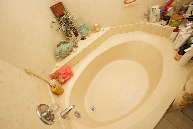 interior details with a bath and tile patterned floors