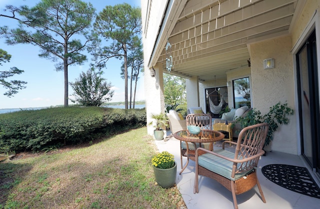 view of yard with a patio and a water view