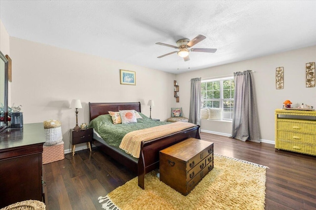 bedroom featuring ceiling fan, a textured ceiling, and dark hardwood / wood-style flooring