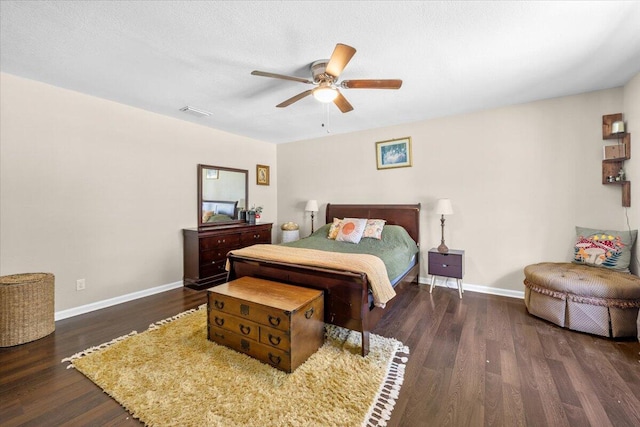 bedroom with ceiling fan, a textured ceiling, and dark hardwood / wood-style floors