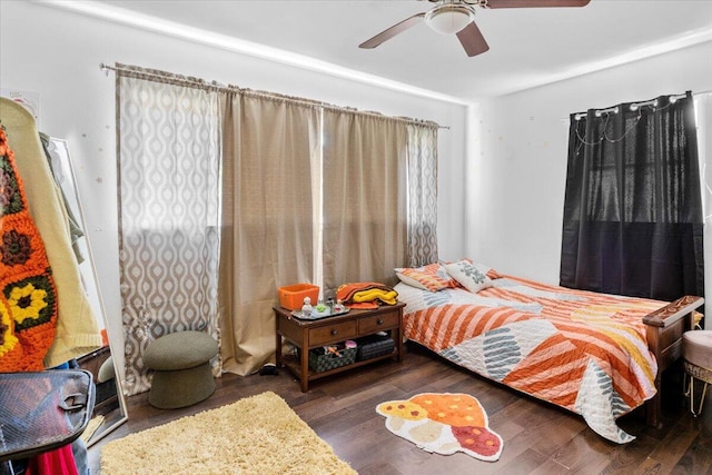 bedroom with dark hardwood / wood-style floors and ceiling fan