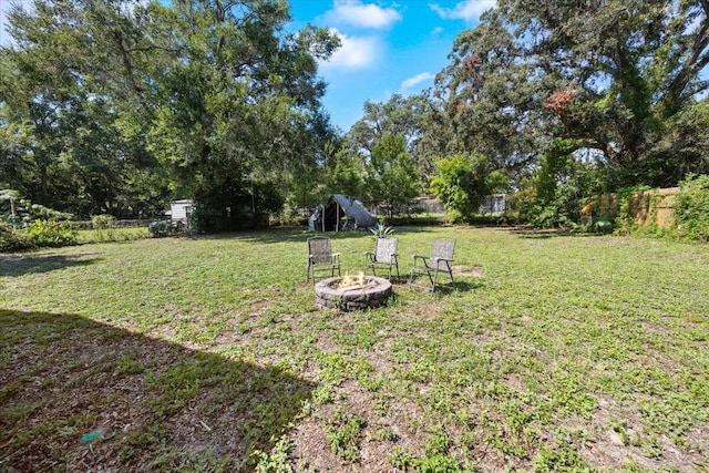 view of yard with a fire pit