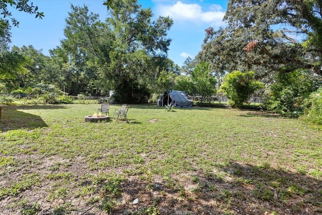 view of yard with an outdoor fire pit