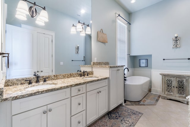 bathroom featuring vanity, a bathtub, and tile patterned flooring