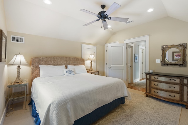 bedroom featuring ceiling fan, light carpet, and vaulted ceiling