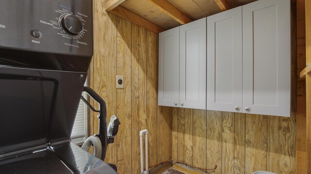 interior space with wood walls and beamed ceiling