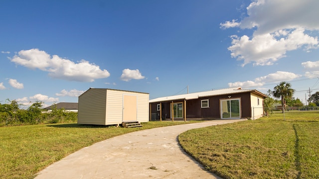 view of front facade with a front yard and a storage unit