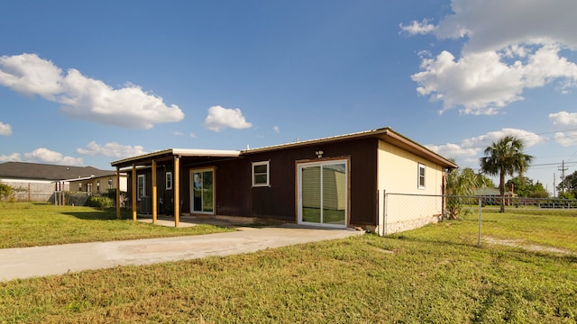 exterior space with a patio and a front lawn