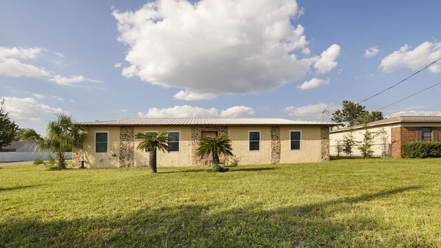 rear view of house with a yard