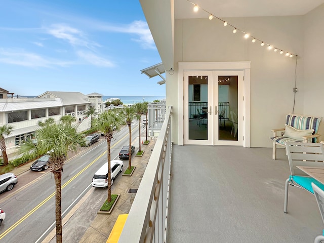 balcony with french doors and a water view