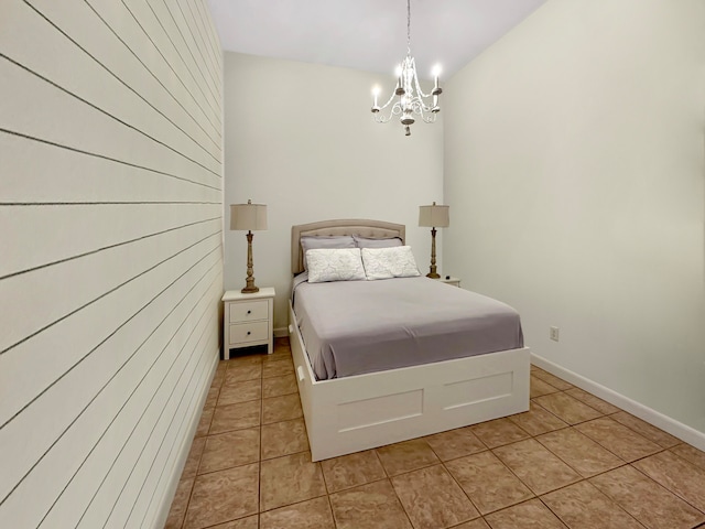 tiled bedroom featuring an inviting chandelier