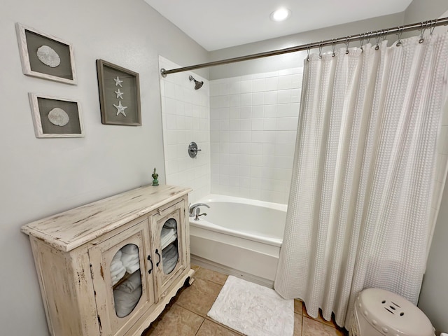 bathroom with tile patterned floors, shower / tub combo with curtain, and toilet