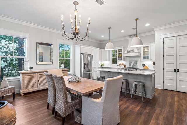 dining room featuring a wealth of natural light, dark hardwood / wood-style flooring, and a chandelier