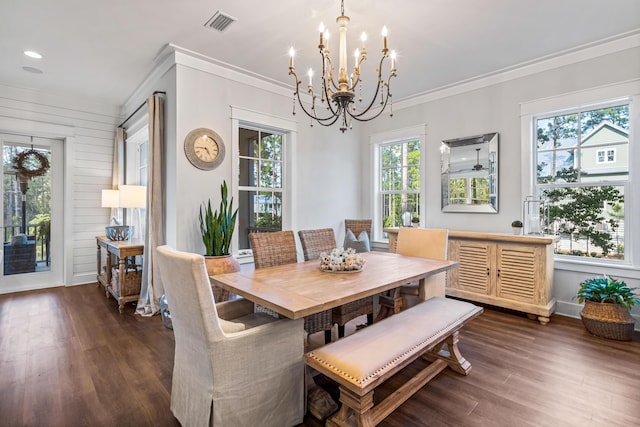 dining space featuring crown molding, plenty of natural light, dark hardwood / wood-style floors, and a notable chandelier