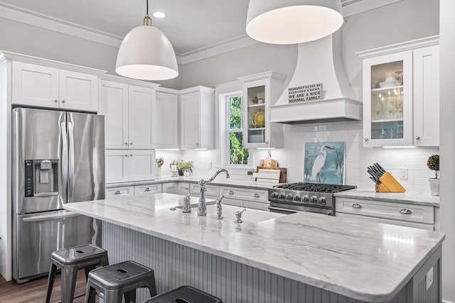 kitchen featuring pendant lighting, custom exhaust hood, sink, white cabinetry, and stainless steel appliances