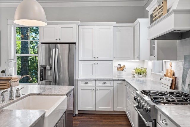 kitchen featuring light stone countertops, sink, appliances with stainless steel finishes, white cabinets, and custom exhaust hood