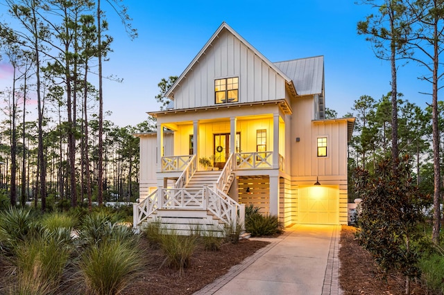 modern inspired farmhouse with covered porch and a garage