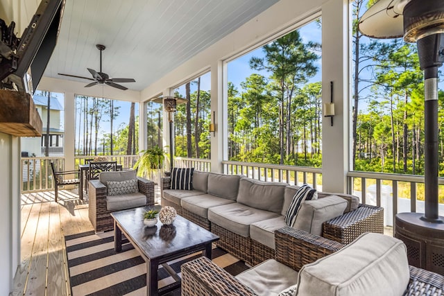 sunroom featuring plenty of natural light, ceiling fan, and wooden ceiling