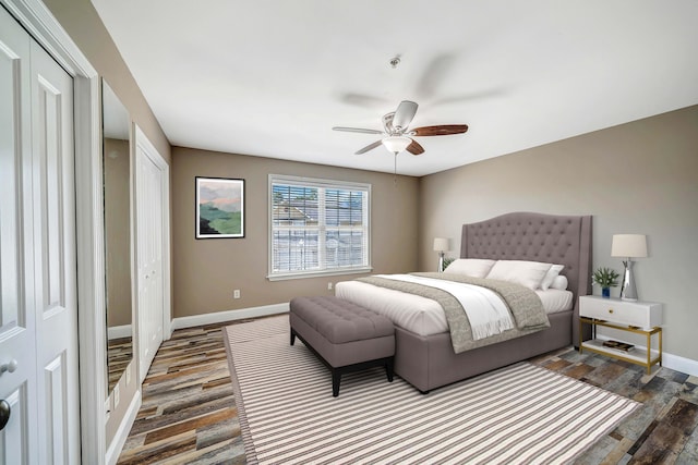 bedroom with baseboards, a ceiling fan, wood finished floors, and a closet
