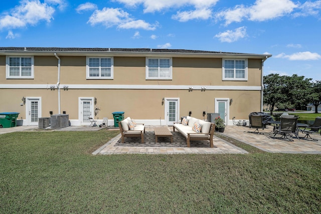 rear view of property featuring a patio area, a lawn, cooling unit, an outdoor hangout area, and stucco siding