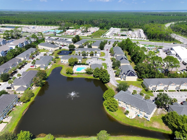 drone / aerial view with a view of trees and a water view