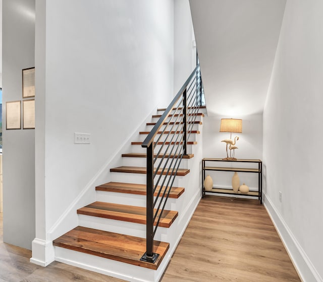 stairs with hardwood / wood-style floors