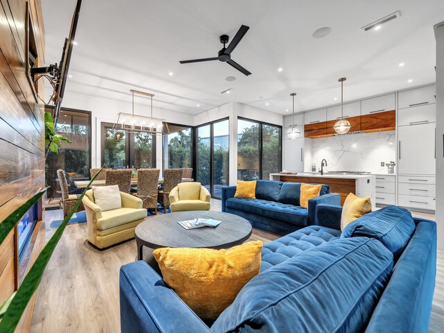 living room featuring light wood-type flooring and ceiling fan