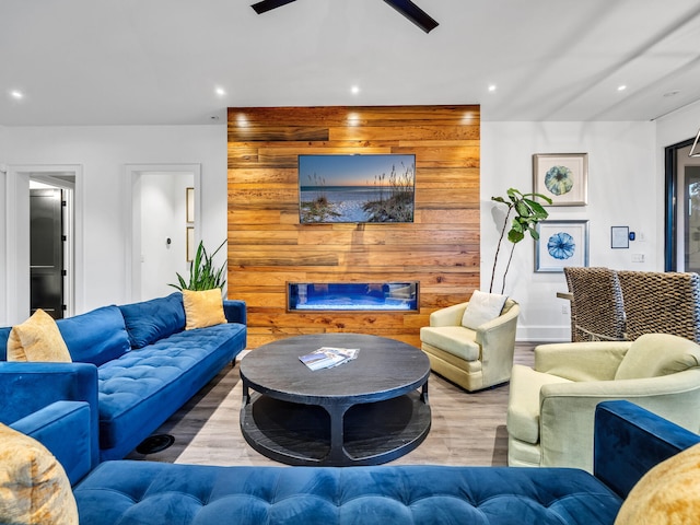 living room featuring wood-type flooring and ceiling fan