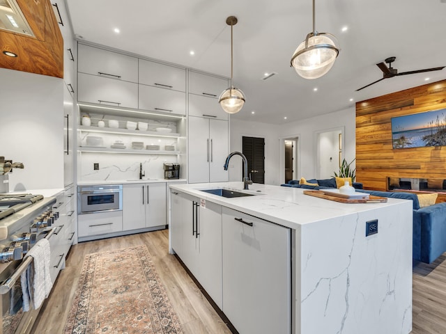 220 N Saint Francis Dr, Miramar Beach, FL 32550 - kitchen featuring modern cabinets, high end stainless steel range oven, open floor plan, a center island with sink, and recessed lighting