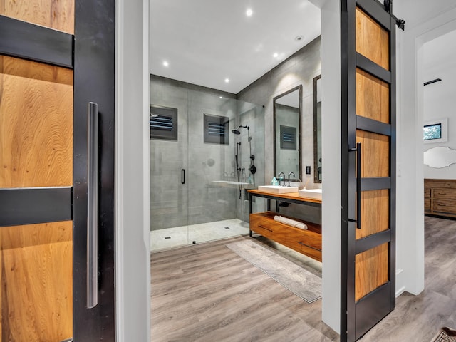 220 N Saint Francis Dr, Miramar Beach, FL 32550 - bathroom featuring double vanity, a stall shower, wood finished floors, and recessed lighting