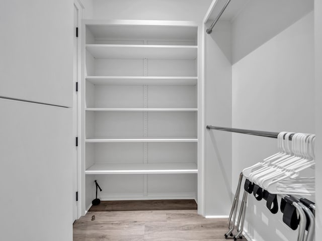 spacious closet with light hardwood / wood-style floors