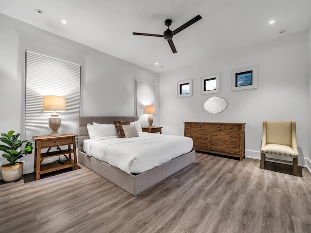 bedroom featuring ceiling fan and light hardwood / wood-style flooring