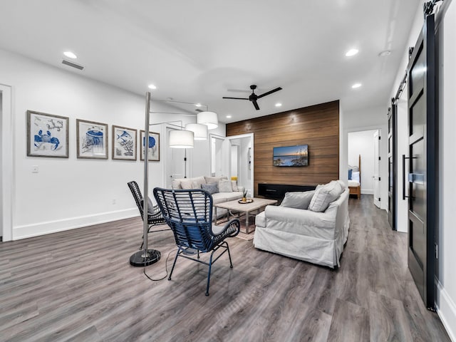 220 N Saint Francis Dr, Miramar Beach, FL 32550 - living room with a barn door, ceiling fan, recessed lighting, and dark wood-type flooring