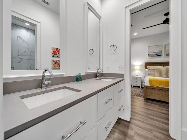220 N Saint Francis Dr, Miramar Beach, FL 32550 - ensuite bathroom featuring double vanity, wood finished floors, recessed lighting, and a marble finish shower